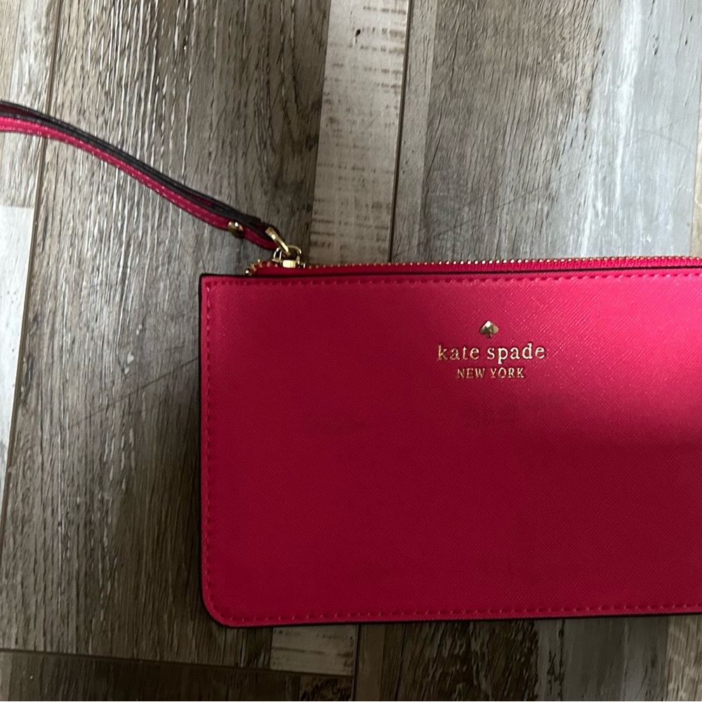 kate spade hot pink wristlet clutch with gold logo